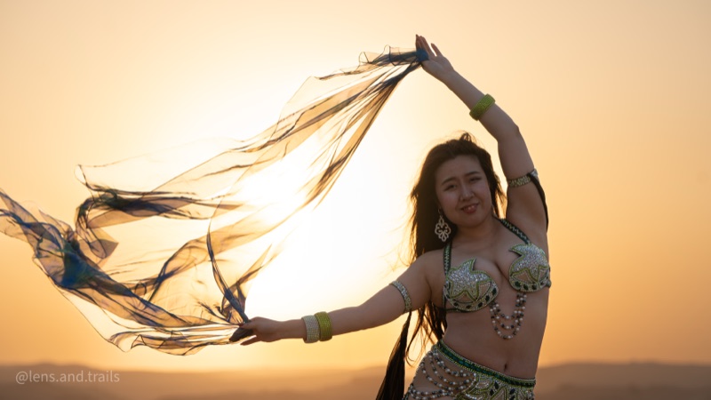 Belly dancer with a sheer veil backlit by the Egyptian sunset
